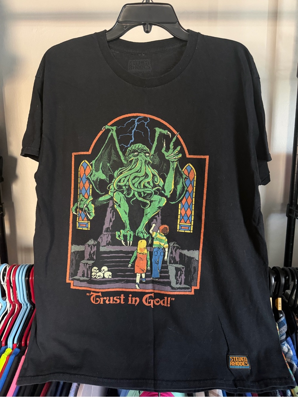 Steven Rhode’s Black Graphic Tee with Cathulu Print ‘Trust in God!’